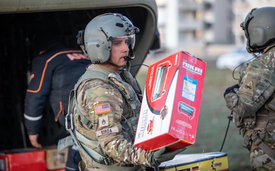 U.S. Army Staff Sgt. Jose Borda distributes relief supplies from his aircraft in Pazarcik, Turkey, on Tuesday, Feb. 14, 2023. 