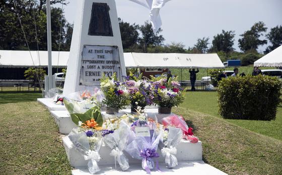 Flowers cover an marking the spot where Ernie Pyle was killed.
