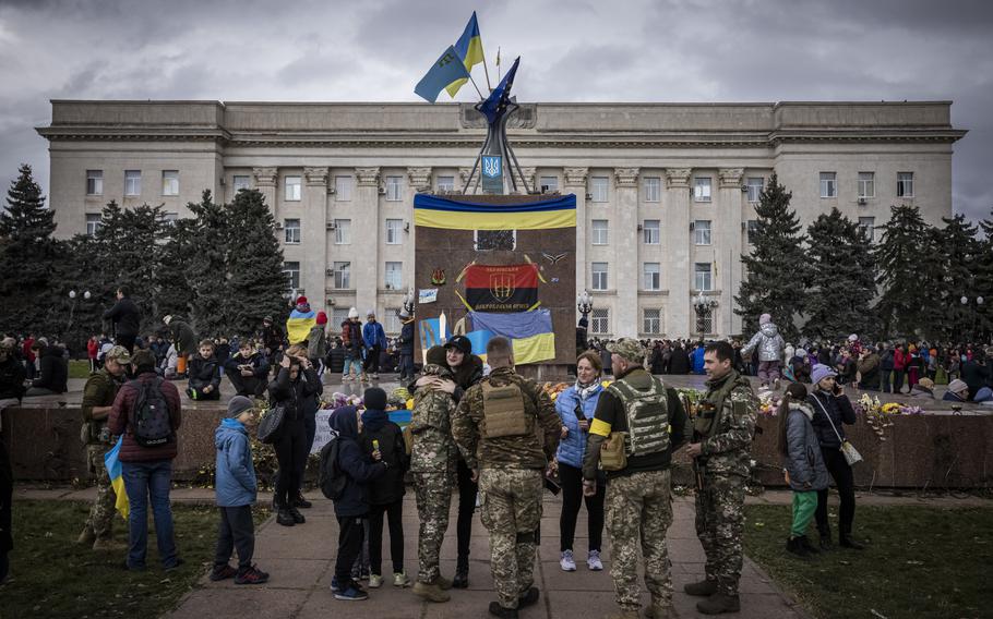 Soldiers hug Kherson residents and pose for photos in the liberated city’s central square, on Nov. 16, 2022.