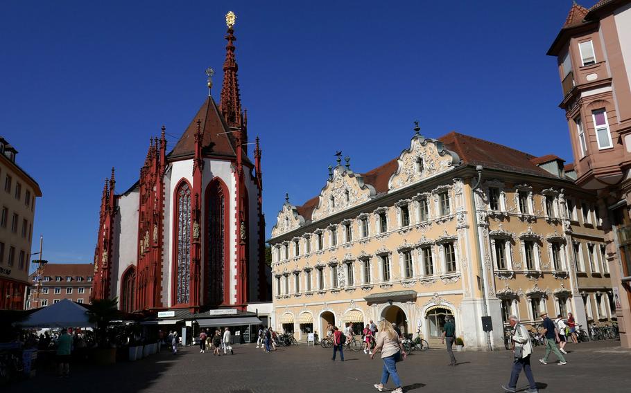 The Falkenhaus, with its 18th-century ornate stucco facade and the Marienkapelle, stand on Wuerzburg, Germany’s market square. Construction on the beautiful late Gothic church began in 1377.