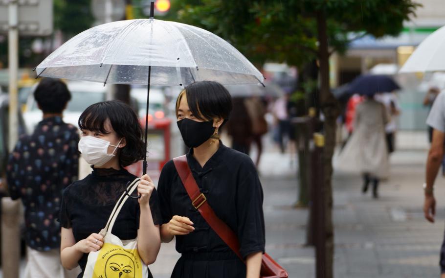 Pedestrians outside Shimbashi Station, Tokyo, wore masks Aug. 13, 2021, to prevent spread of the coronavirus.  