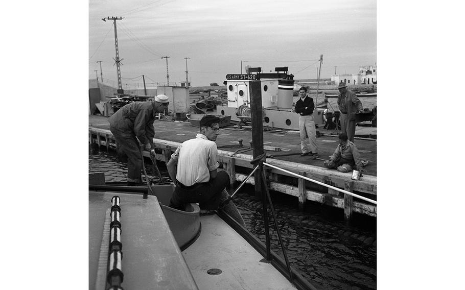 Airman 2nd Class Alvin R. Penry pulls in rope as his crew members of the Air Force’s 7th Crash Rescue Boat Flight cast off in Tripoli harbor, Libya. Normally the Navy would provide crash boat service to a coastal air base, but since there were no Navy detachments in the area, the Air Force had to provide its own. Similar units are maintained by the Air Force around the world, the largest being at West Palm Beach, Fla.