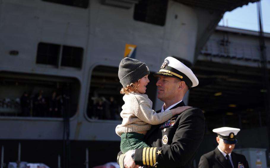 Capt. Justin Issler, executive officer for the USS Ronald Reagan, picks up his son Friday, Dec. 16, 2022, after the carrier returned to Yokosuka Naval Base, Japan
