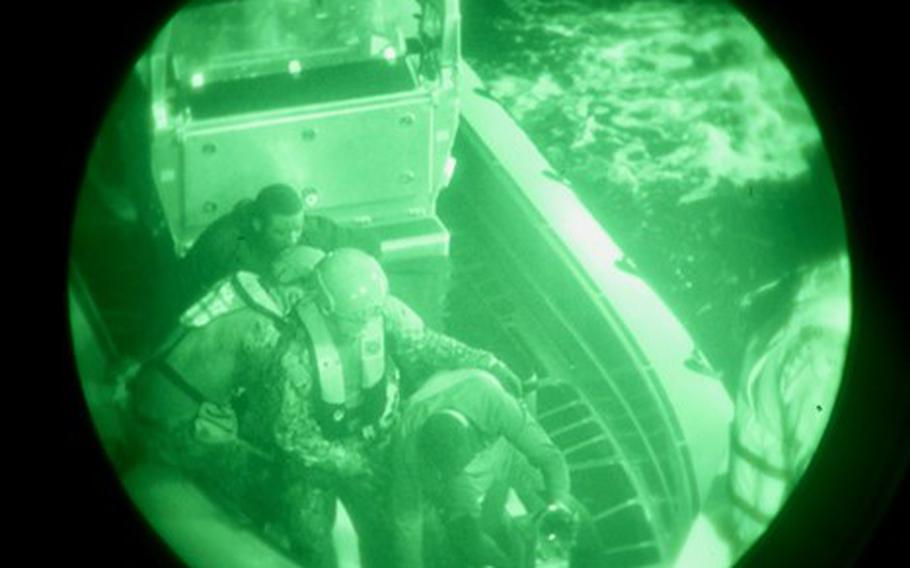Crew members of the U.S. Coast Guard cutter Glen Harris rescue migrants from the water in the Atlantic Ocean Jan. 5, 2022.
