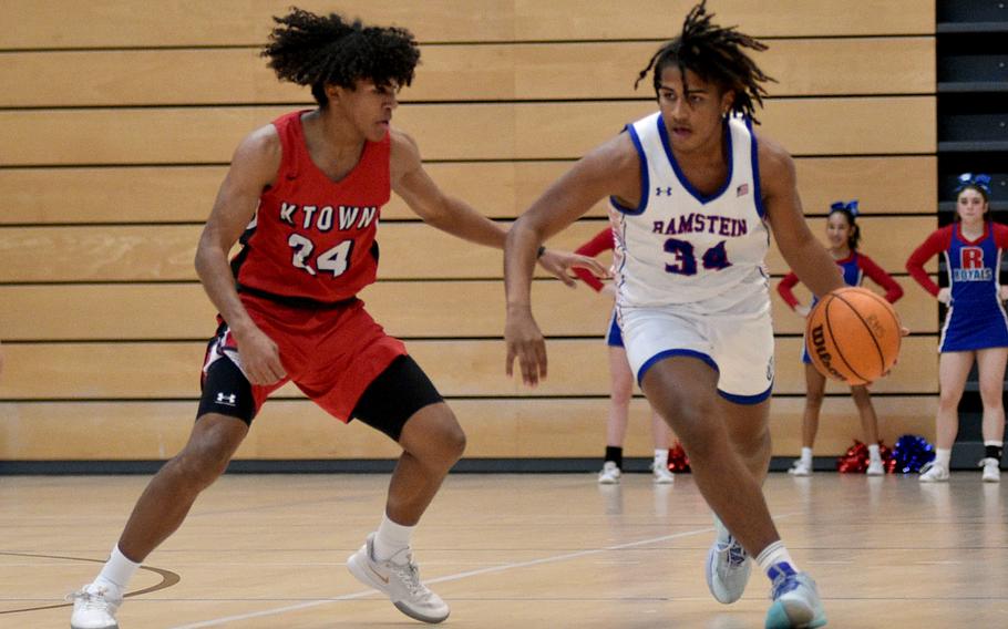 Ramstein junior Tyrell Edwards dribbles as Kaiserslautern junior Rueben Todman defends during pool-play action of the DODEA European basketball championships on Feb.14, 2024, at the Wiesbaden Sports and Fitness Center on Clay Kaserne in Wiesbaden, Germany.