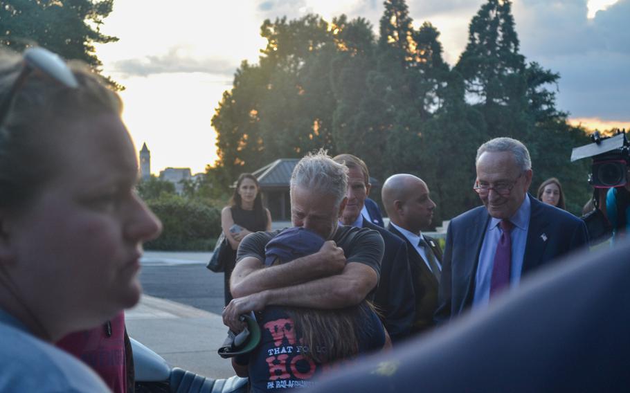 Comedian Jon Stewart and Rosie Torres, co-founder and executive director of the advocacy group Burn Pits 360, hug Tuesday, Aug. 2, 2022, after the Senate passed the PACT Act by a vote of 86 to 11. Torres said her husband, Army Reserve veteran LeRoy Torres, deployed to Camp Anaconda in Iraq and returned with terminal lung disease, toxic brain injury and autoimmune issues.