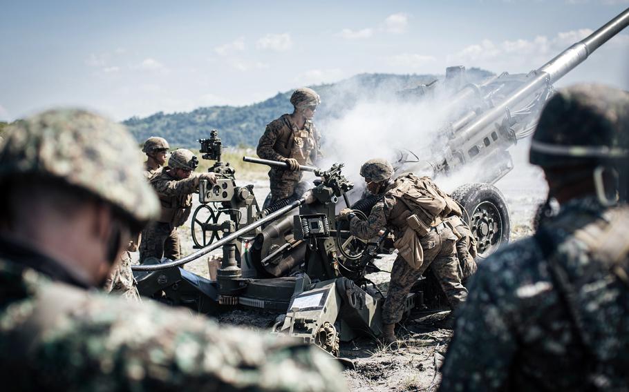 Philippine marines observe their U.S. counterparts conduct a fire mission at Colonel Ernesto Ravina Air Base, Philippines, during exercise Kamandag in 2019. 