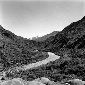 A scenic view of a river snaking between hills/mountains.