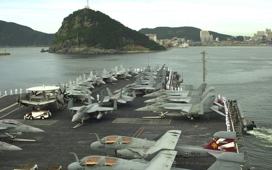 Busan, South Korea, July 25, 2010: The USS George Washington pulls away from Busan in South Korea on its way to participate in the Invincible Spirit joint military exercise being staged for four days by the U.S. and South Korea.    

Read Jon Rabiroff's story on Invincible Spirit here https://www.stripes.com/news/u-s-s-korea-aim-to-strike-the-right-tone-as-exercise-kicks-off-1.112245

META TAGS: USS George Washington, U.S. Navy; aircraft carrier; Nimitz class; nuclear-powered carrier;                        