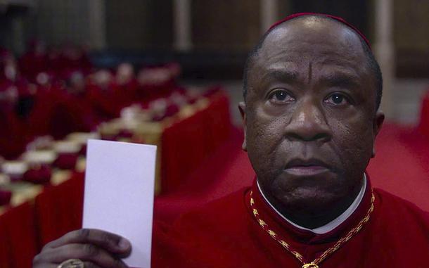 Lucian Msamati holds up a piece of paper in “Conclave.”