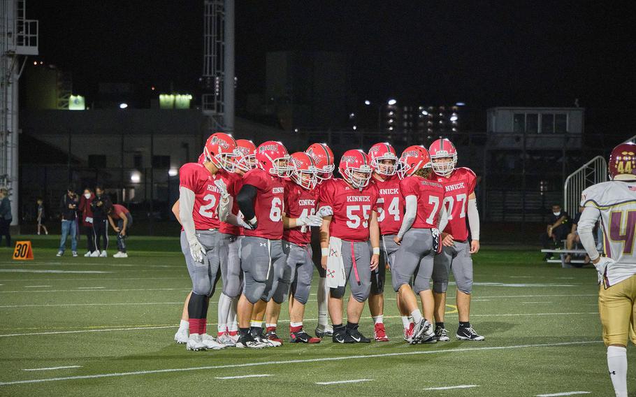 Nile C. Kinnick players huddle during a game against Matthew C. Perry on Friday, Sept. 17, 2021.