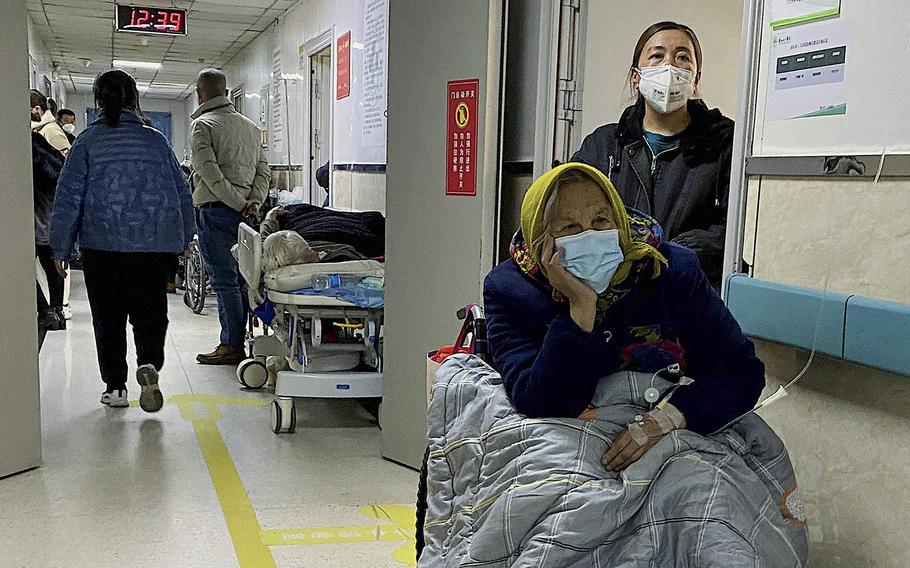 A patient with Covid-19 rests in a wheelchair in a hallway at Tangshan Gongren Hospital in China’s northeastern city of Tangshan on Dec. 30, 2022. 