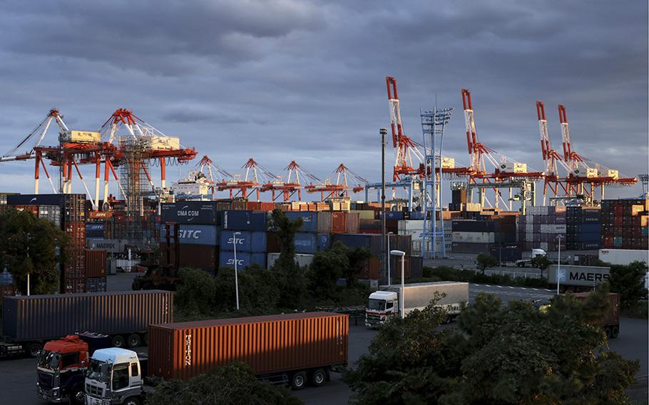 Gantry cranes and containers are seen at a shipping terminal in Yokohama, Japan, on Oct. 18, 2021.
