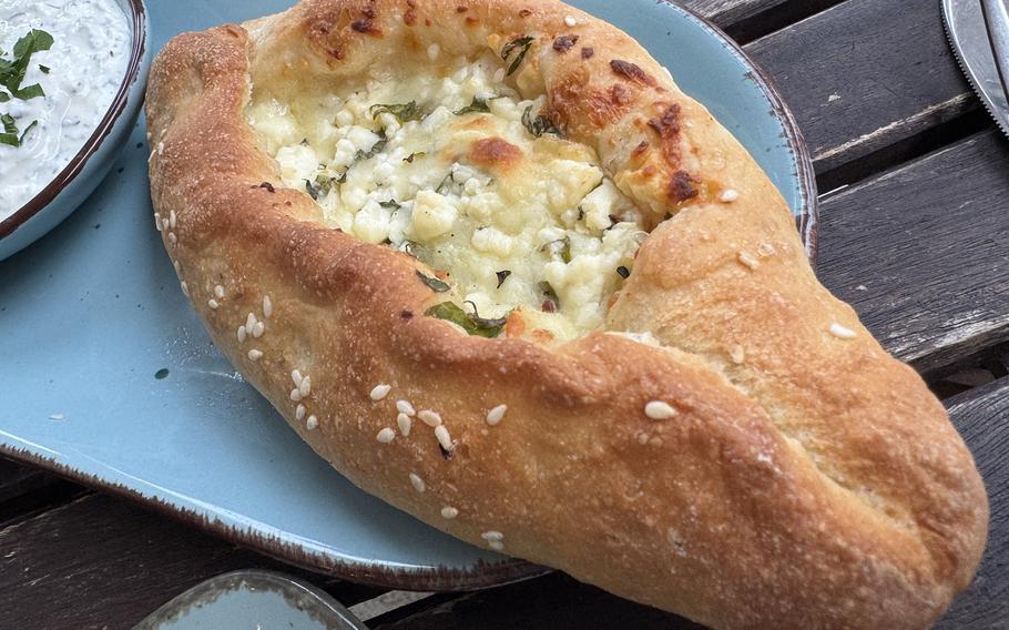 a large piece of turkish bread with white cheese in the middle