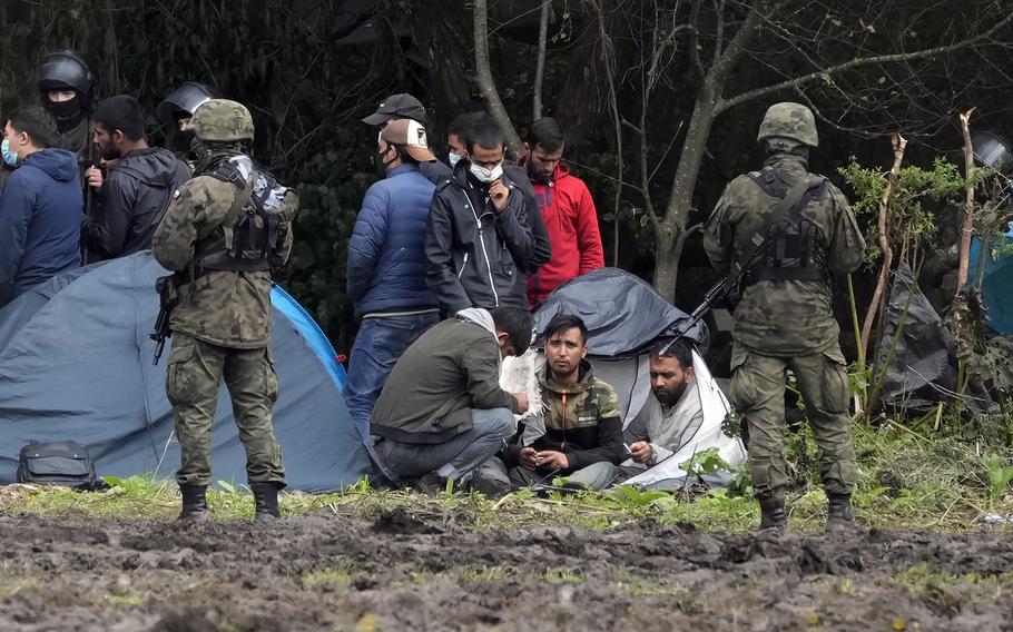 Polish security forces surround migrants stuck along with border with Belarus in Usnarz Gorny, Poland, on Sept. 1, 2021.