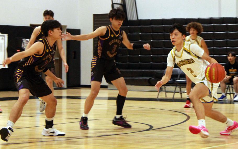 Humphreys' Junho Yi has his path to the basket cut off by two Gyeonggi Suwon defenders during Wednesday's Korea boys basketball game. The Knights won 75-63.