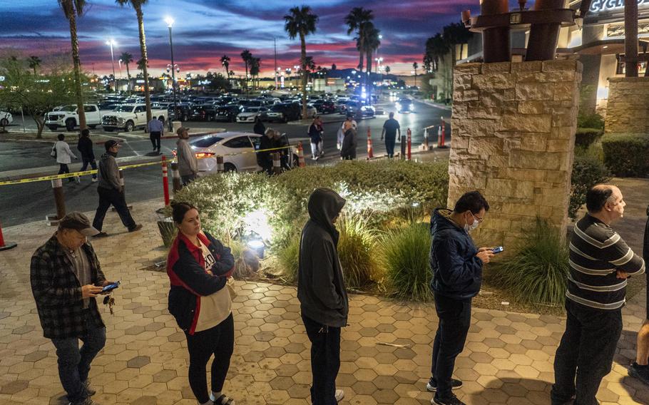 A long line of Nevada voters wait outside to cast their votes at a polling place in Las Vegas on Friday, the last day of early voting. 