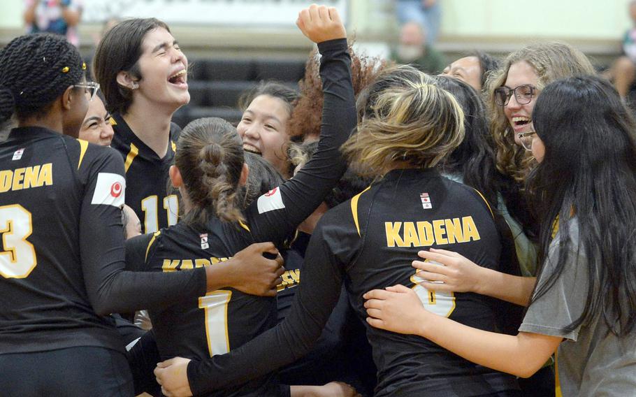 Kadena's volleyball players and managers celebrate the team's first victory over Kubasaki in more than 10 years.