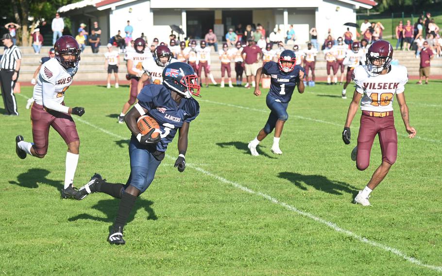 After catching a pass, Lakenheath’s David Kumi-Baah turns and carries the ball up field during the third quarter of a game against Vilseck on Friday, Sept. 15 in Vilseck, Germany.