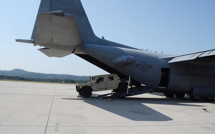 A Humvee is offloaded from a C-130H at Ramstein Air Base in Germany during the 721st Aerial Port Squadron Multi-Capable Airmen Rodeo, July 23, 2021.