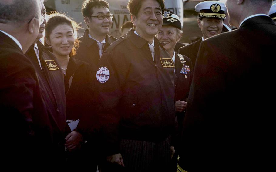 Japanese Prime Minister Shinzo Abe visits the aircraft carrier USS Ronald Reagan on Oct. 18, 2015.