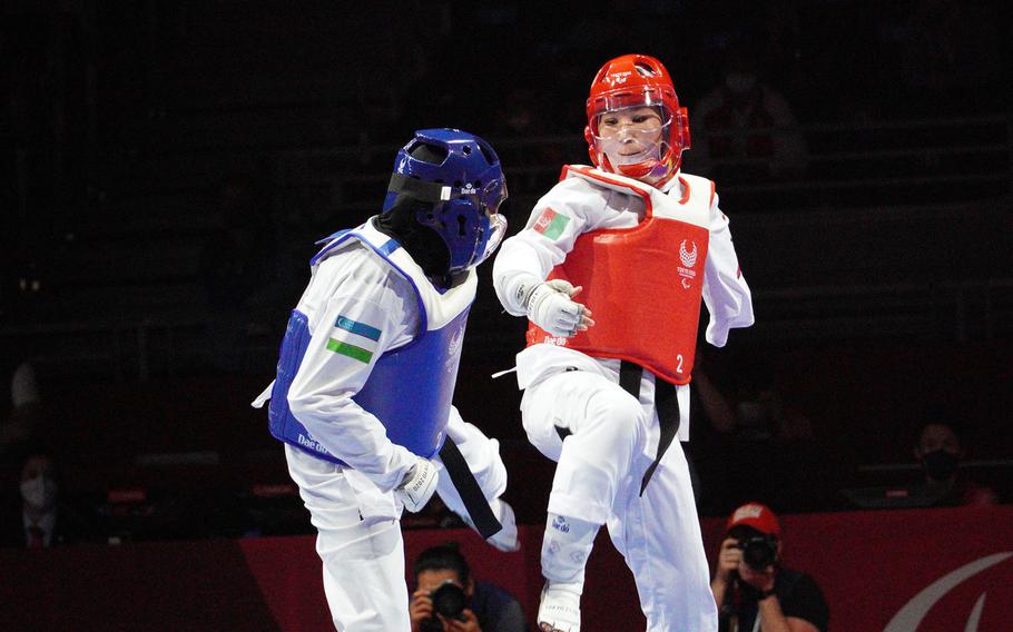 Afghan Taekwondo athlete Zakia Khudadadi, in red, shapes up to Uzbek Ziyodakhon Isakova during the Tokyo Paralympics in Chiba prefecture, Japan, Thursday, Sept. 2, 2021. 