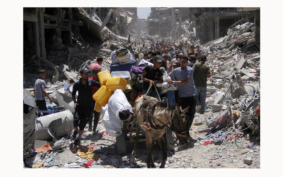 Rubble fills a thoroughfare in Gaza on May 31, 2024, as people and animals try to navigate through the destruction.