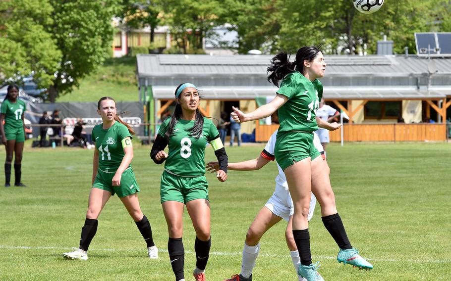 Naples defender Amber Ozturloglu, right, heads away a cross during the Wildcats' Division II semifinal against American Overseas School of Rome at the DODEA European soccer championships on May 17, 2023, at VfR Baumholder's stadium in Baumholder, Germany. Watching, from left, are Wildcat teammates Emma Kasparek and Nadia Shimasaki.