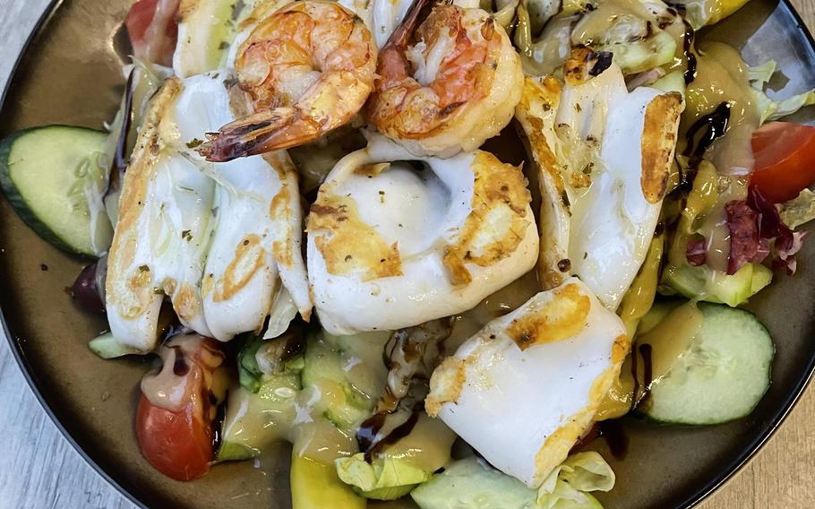 The Santorini salad at Pallas Greek restaurant in Weiden, Germany, contains grilled calamari and scampi and is covered in a honey balsamic dressing.