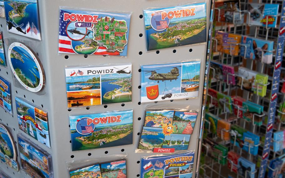 Souvenir magnets show scenes from Powidz, Poland, with U.S. military equipment and American flags.