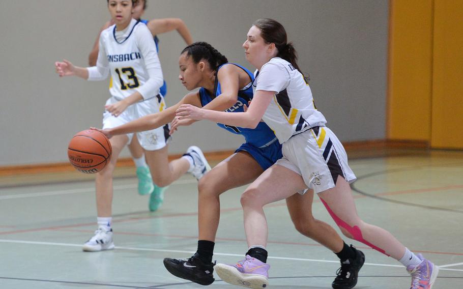 Ansbach’s Trinity Batin, right, tries to stop a fast break by Hohenfels’ Malea Jobity in a D-III game on opening day of the DODEA-Europe basketball finals in Baumholder, Germany, Feb. 15, 2023. Ansbach won the game 47-34.