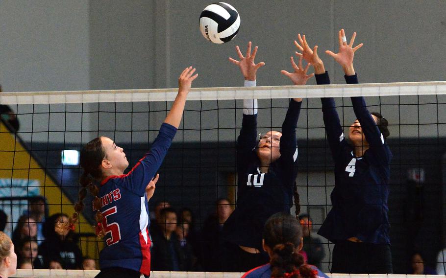 Aviano’s Stella Beckwith-Wolf hits the ball over the net against Black Forest Academy defenders Xofia Pineda Wood, center, and Haewon Park. Aviano beat BFA 25-19, 25-21, 24-26, 25-23 to capture the Division II DODEA-Europe volleyball crown at Ramstein, Germany, Oct. 28, 2023.
