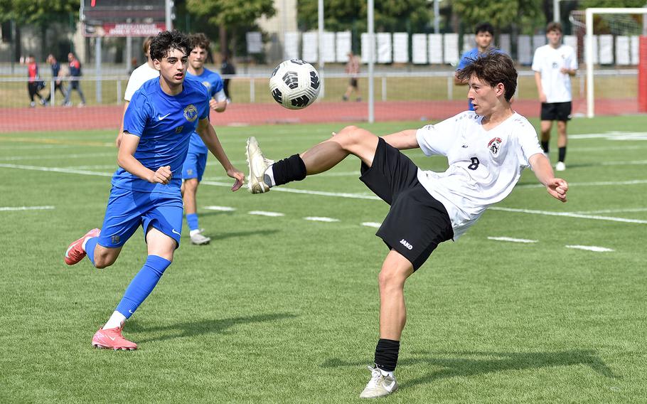 Kaiserslautern midfielder Wesley Manson kicks the ball while Ramstein defender Nathan Rachamim comes forward during a Division I semifinal match at the 2025 DODEA European championships on May 21, 2025, at Kaiserslautern High School in Kaiserslautern, Germany.