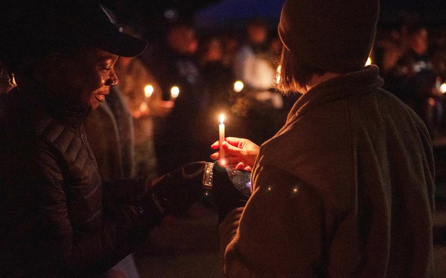 A candlelight vigil is held in honor of those affected by suicide, domestic violence, sexual assault and harassment at Spangdahlem Air Base, Germany, Sept. 30, 2022. The stories of victims affected were read during the lighting of candles.