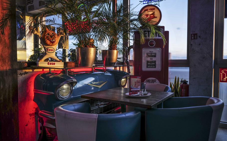 A corner seating area at Freeway Restaurant in Ruesselsheim, Germany, offers retro American diner flair, complete with Chevy headlights and neon signs.