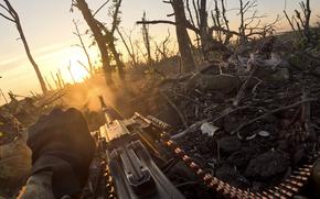In this image taken from a video released by the 3rd Assault Brigade, a Ukrainian servicemen fires machine gun towards Russian positions near Andriivka, Donetsk region, Ukraine, Aug. 27, 2023. Ukrainian brigade's two-month battle to fight its way through a charred forest shows the challenges of the country's counteroffensive in the east and south.