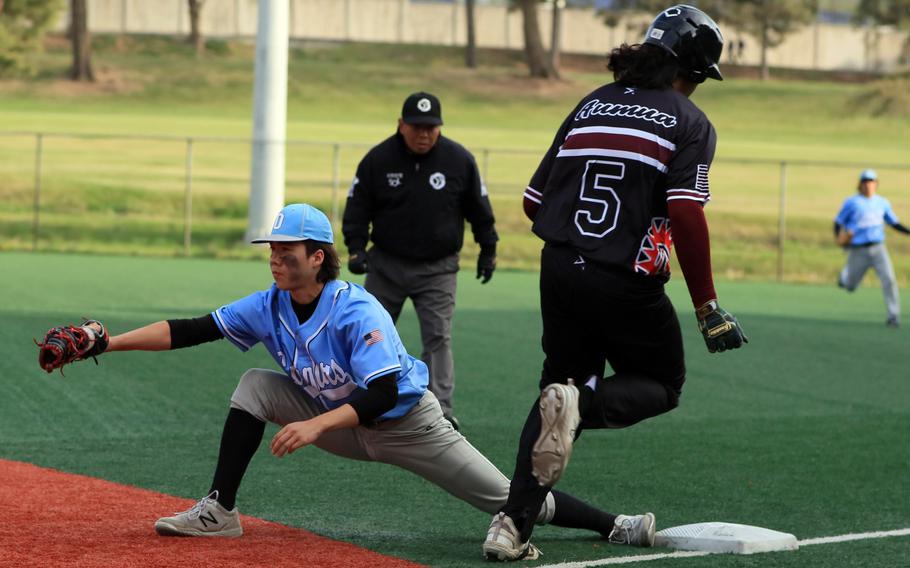 Osan first baseman Adam Rutland snags the throw before Zama's Rhino Aumua crosses the bag.