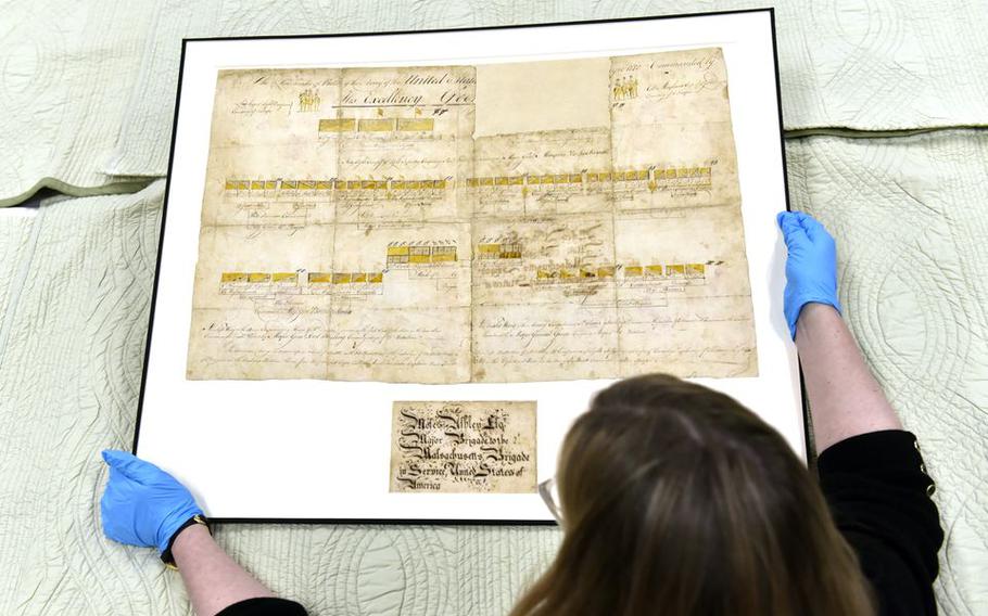 Amanda Lange, Curatorial Department Director and Curator of Historic Interiors at Historic Deerfield, looks over the recently restored Revolutionary War battle plan document by Major Moses Ashley of Westfield.