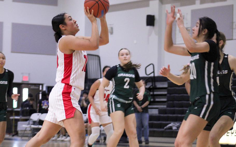 Kinnick’s Leona Turner shoots against Kubasaki’s Runa Holladay. The Red Devils won 31-19.