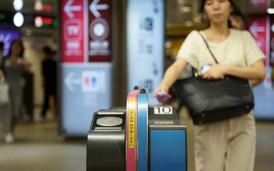 A commuter enters the Denentoshi Line at Shibuya Station in Tokyo, Wednesday, Aug. 23, 2023. 