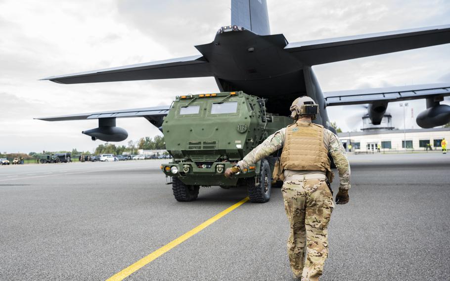 A U.S. Air Force loadmaster offloads a High Mobility Artillery Rocket System, or HIMARS, in Liepaja, Latvia, on Sept. 26, 2022. The mobile rocket systems are being flown to the Arctic, the Baltics and beyond as the U.S. Army puts a spotlight on a weapons system that is gaining attention for its effectiveness on the battlefield in Ukraine.