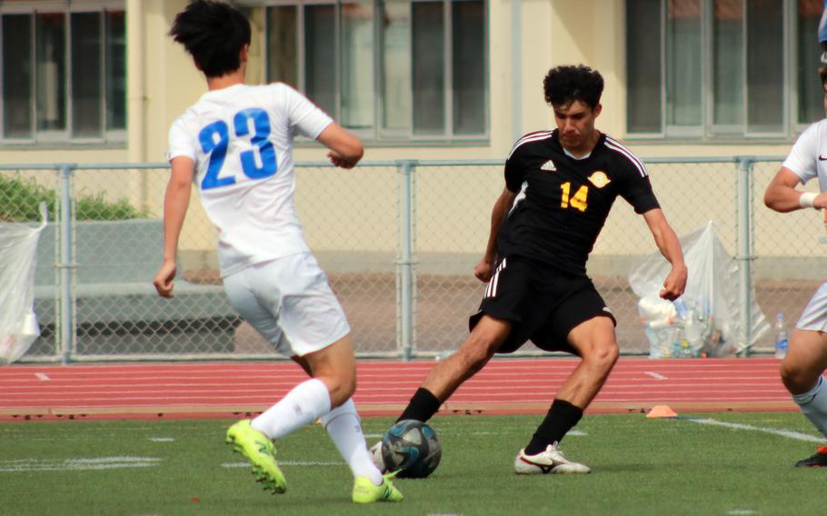 Kadena's Gabriel Cedeno and CAJ's Takuma Seto chase the ball.
