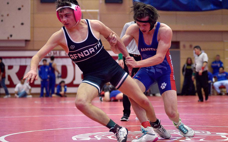 Ramstein's Jayden Andrews holds onto AFNORTH's Deacon Smith during a 138-pound semifinal match at a wrestling meet on Jan. 27, 2024, at Kaiserslautern High School in Kaiserslautern, Germany.