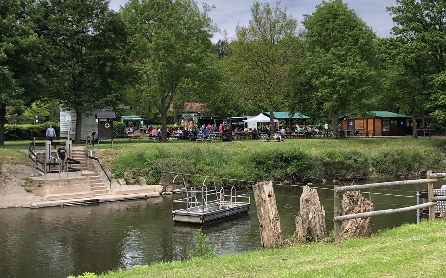 Hikers can pull themselves across the Nahe River in a boat to return to the entrance and beer garden at the barefoot park in Bad Sobernheim, Germany.