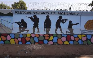FILE - A mural is seen in Ouagadougou, Burkina Faso, Wednesday March 1, 2023. Three survivors of an attack in Zaongo, central Burkina Faso, told AP that dozens of people were killed in their village on Nov. 5 when security forces attacked. One of the survivors, a 32-year-old farmer, said he photographed the horrific scenes of bodies as proof of the carnage before fleeing. (AP Photo, File)