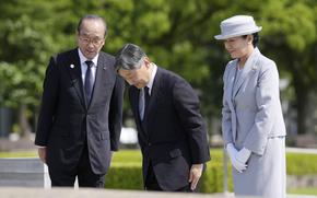 Japanese Emperor Naruhito, center, and Empress Masako bow in front of the cenotaph dedicated to the victims of the atomic bombing as they visit the Peace Memorial Park in Hiroshima, western Japan Thursday, June 19, 2025. Hiroshima Mayor Kazumi Matsui is at left. (Kai Naito/Kyodo News via AP)