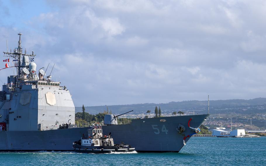 The Ticonderoga-class guided missile-cruiser USS Antietam (CG 54) passes the USS Arizona memorial as it arrives at its new homeport at Joint Base Pearl Harbor-Hickam, Hawaii, Friday, April 5, 2024. 