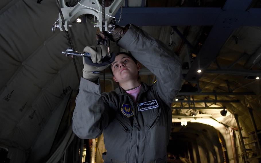 Senior Airman Marissa Antillonloya, a loadmaster with the 37th Airlift Squadron, adjusts a cable inside a C-130J for a static line jump. Antillonloya was one of 17 women who flew on an all-women, three-aircraft formation training flight on March 18, 2022, out of Ramstein Air Base.