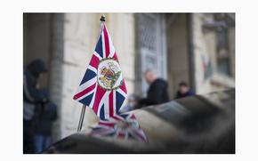 FILE - The British Union flag flies from the front of British ambassador to Russia's car, next to the Russian foreign ministry building in Moscow, Russia, on March 17, 2018. Russia has declared Britain’s defense attaché persona non grata and gave the diplomat a week to leave the country in response to London expelling the Russian defense attaché earlier this month over spying allegations. (AP Photo/Pavel Golovkin, File)