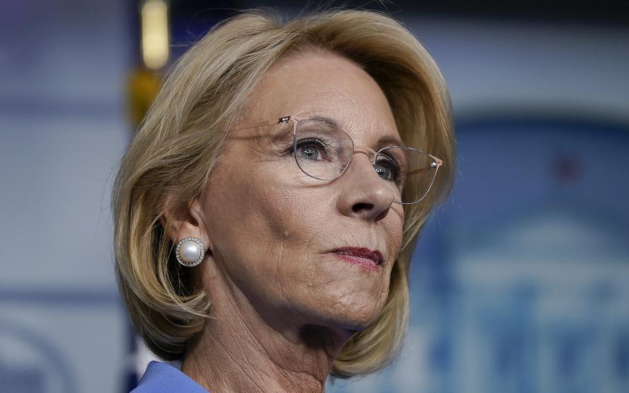 Then-Secretary of Education Betsy DeVos listens during a briefing at the White House on March 26, 2020, in Washington, D.C.